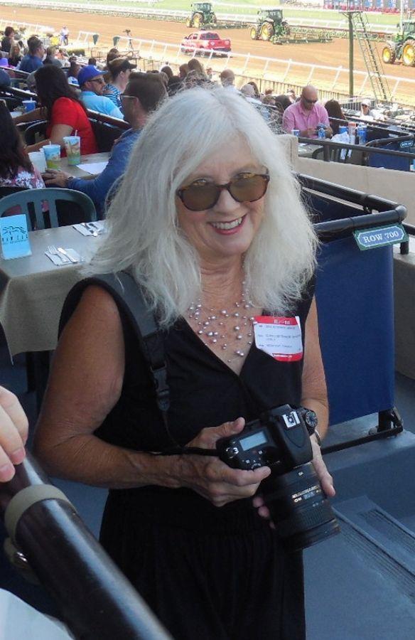 guest in black dress holding a camera